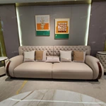Cream Tufted Leather Sofa with Deep-Red High-Gloss Wood Side Panels